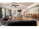 Comfortable living room with wood-look floors, ceiling fan, a staircase, dining room and kitchen in the background at 165 Colony Cir, Canton, GA 30114