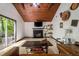 Living room with a beamed wood ceiling, fireplace, and sliding doors that lead to a deck at 165 Colony Cir, Canton, GA 30114
