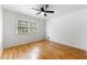 A bright bedroom featuring hardwood floors, neutral walls, and a ceiling fan at 2702 Galaxy Ct, Decatur, GA 30034