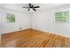 Spacious bedroom with hardwood floors, a ceiling fan, and dual windows at 2702 Galaxy Ct, Decatur, GA 30034