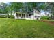 Charming two-story home with a well-manicured front yard, lovely blue door, and black shutters at 2702 Galaxy Ct, Decatur, GA 30034