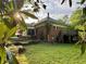 Exterior view of the home with a backyard, stone stairs, and greenery at 3366 College St, College Park, GA 30337