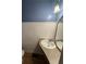 Cozy half bathroom with blue walls, wainscoting and a unique mirror and sink at 3366 College St, College Park, GA 30337