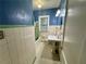 Bathroom featuring blue and white tiling, a tub and shower, and a pedestal sink at 3366 College St, College Park, GA 30337