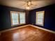 Bedroom featuring two windows with blinds offering natural light and hardwood floors at 3366 College St, College Park, GA 30337