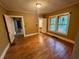 Bedroom featuring hardwood floors and two windows offering natural light with neutral walls at 3366 College St, College Park, GA 30337