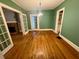 Dining room with hardwood floors, French doors, and green walls at 3366 College St, College Park, GA 30337