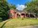 Charming brick home with mature trees and a well-maintained front yard at 3366 College St, College Park, GA 30337