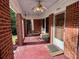 Inviting front porch featuring brick columns, swing, and ceiling fan at 3366 College St, College Park, GA 30337