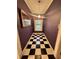 Hallway with checkerboard floors and a mirror at 3366 College St, College Park, GA 30337