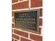 Historical plaque indicating listing in the National Register of Historic Places on an exterior brick wall at 3366 College St, College Park, GA 30337