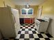 Bright kitchen featuring checkerboard floors, red cabinets, and a gas range at 3366 College St, College Park, GA 30337