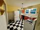 Kitchen featuring checkerboard floors, red and white cabinets, and lots of natural light at 3366 College St, College Park, GA 30337
