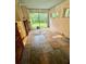 Bright sunroom featuring windows, tile flooring and access to the outdoors at 3366 College St, College Park, GA 30337