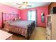 Unique pink bedroom with carpeted floors, window, and statement wall at 1830 Brandy Se Ln, Conyers, GA 30013