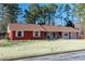 Charming single-story home with a red brick exterior and a well-manicured front yard at 1830 Brandy Se Ln, Conyers, GA 30013