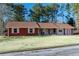 Charming brick home featuring white shutters and a well-maintained front lawn at 1830 Brandy Se Ln, Conyers, GA 30013