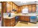Functional kitchen with wooden cabinets, white countertops, and modern appliances at 1830 Brandy Se Ln, Conyers, GA 30013