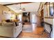 Cozy living room featuring a brick fireplace, ceiling fan, and hardwood floors at 1830 Brandy Se Ln, Conyers, GA 30013
