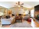Spacious living room featuring a large sectional sofa, brick fireplace, and natural light at 1830 Brandy Se Ln, Conyers, GA 30013
