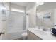 Well-lit bathroom featuring a shower-tub combination, neutral tile, and stylish fixtures at 295 Cranston Dr, Canton, GA 30114