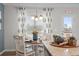 Bright dining area featuring a round table, white chairs, and stylish patterned curtains at 295 Cranston Dr, Canton, GA 30114