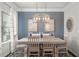 Elegant dining room featuring a modern chandelier, a bright window and stylish décor accents at 295 Cranston Dr, Canton, GA 30114