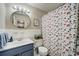 Cozy bathroom featuring a blue vanity, round mirror, and patterned shower curtain at 311 Peachtree Hills Ne Ave # 10C, Atlanta, GA 30305
