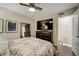 Well-lit bedroom with wood-look ceiling fan, large television, and dresser at 311 Peachtree Hills Ne Ave # 10C, Atlanta, GA 30305