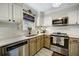 Well-lit kitchen featuring stainless steel appliances, neutral cabinetry, and granite countertops at 311 Peachtree Hills Ne Ave # 10C, Atlanta, GA 30305