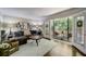 Cozy living room with a brown leather couch, decorative pillows, a wood table, and balcony access at 311 Peachtree Hills Ne Ave # 10C, Atlanta, GA 30305