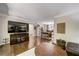 Spacious living room featuring hardwood flooring, media center, and an open layout connected to dining area at 311 Peachtree Hills Ne Ave # 10C, Atlanta, GA 30305