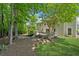 A house with a deck and a large grassy yard is framed by mature trees, offering a serene view at 6034 Farmwood Se Way, Mableton, GA 30126