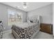 Cozy bedroom featuring a comfortable bed, ceiling fan, and bright window at 6034 Farmwood Se Way, Mableton, GA 30126