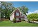 Charming two-story brick home with a well-manicured lawn, and mature trees enhancing its curb appeal at 6034 Farmwood Se Way, Mableton, GA 30126