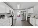 Modern kitchen with white countertops and stainless steel appliances leading into a bright playroom at 6034 Farmwood Se Way, Mableton, GA 30126