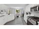 Modern kitchen featuring white countertops, stainless steel appliances, and an adjacent dining area at 6034 Farmwood Se Way, Mableton, GA 30126