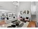 Modern living room with high ceilings, a cozy seating area, and an adjacent kitchen at 6034 Farmwood Se Way, Mableton, GA 30126