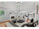 Bright, open living room featuring a fireplace, hardwood floors, and modern lighting fixture at 6034 Farmwood Se Way, Mableton, GA 30126