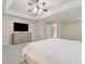 Spacious main bedroom features a tray ceiling, ceiling fan, and great lighting at 6034 Farmwood Se Way, Mableton, GA 30126