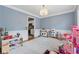 Spacious playroom with stylish decor and a glimpse into the adjacent well-appointed kitchen at 6034 Farmwood Se Way, Mableton, GA 30126