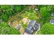 Aerial view of a home, showcasing its extensive backyard, shed, and surrounding greenery at 1384 Sunrise Way, Lawrenceville, GA 30046