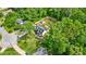 Aerial view of a home with big yard, and a shed surrounded by lush trees at 1384 Sunrise Way, Lawrenceville, GA 30046