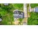 Aerial view of a home, highlighting the roof, long driveway, and lush surrounding trees at 1384 Sunrise Way, Lawrenceville, GA 30046