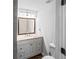 Bathroom offers a vanity with a framed mirror, granite counters, and modern fixtures at 1384 Sunrise Way, Lawrenceville, GA 30046