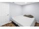 Bedroom showcasing simple design with cozy bed, wood flooring, and white door at 1384 Sunrise Way, Lawrenceville, GA 30046