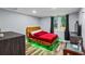 Bedroom featuring a stylish bed with wooden frame, hardwood floors and a bright window at 1384 Sunrise Way, Lawrenceville, GA 30046