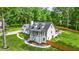 Charming home boasts curb appeal with a well-kept lawn, inviting entrance, and is surrounded by mature trees at 1384 Sunrise Way, Lawrenceville, GA 30046