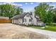 View of the house showing the garage, long driveway and landscaped side yard at 1384 Sunrise Way, Lawrenceville, GA 30046