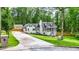 Exterior view of a charming home with well-maintained landscaping and long driveway at 1384 Sunrise Way, Lawrenceville, GA 30046